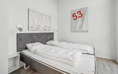 Ein Bett oder Betten in einem Zimmer der Unterkunft Dünenvilla 1, Whg 5