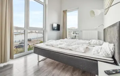Ein Bett oder Betten in einem Zimmer der Unterkunft Dünenvilla 1, Whg 5