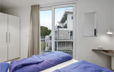 Ein Bett oder Betten in einem Zimmer der Unterkunft Dünenvilla 2, Whg 4