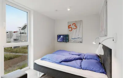 Ein Bett oder Betten in einem Zimmer der Unterkunft Dünenvilla 2, Whg 4