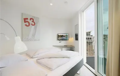 Ein Bett oder Betten in einem Zimmer der Unterkunft Dünenvilla 8, Whg 1