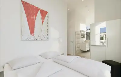 Ein Bett oder Betten in einem Zimmer der Unterkunft Dünenvilla 8, Whg 5