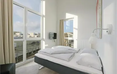Ein Bett oder Betten in einem Zimmer der Unterkunft Dünenvilla 9, Whg 5
