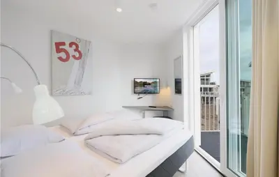 Ein Bett oder Betten in einem Zimmer der Unterkunft Dünenvilla 10, Whg 3