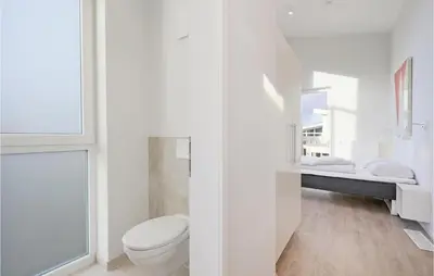Ein Bett oder Betten in einem Zimmer der Unterkunft Dünenvilla 10, Whg 5
