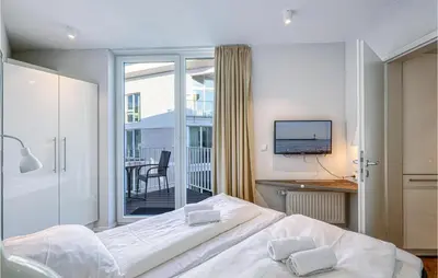Ein Bett oder Betten in einem Zimmer der Unterkunft Dünenvilla 17, Whg 1