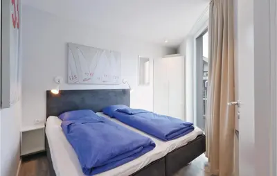 Ein Bett oder Betten in einem Zimmer der Unterkunft Dünenvilla 17, Whg 1
