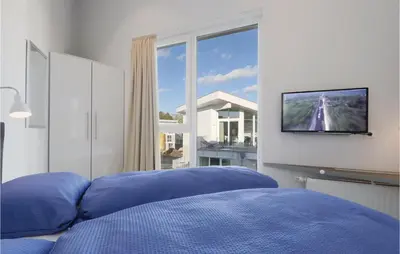 Ein Bett oder Betten in einem Zimmer der Unterkunft Dünenvilla 17, Whg 9