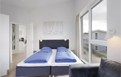 Ein Bett oder Betten in einem Zimmer der Unterkunft Dünenvilla 17, Whg 10