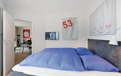 Ein Bett oder Betten in einem Zimmer der Unterkunft Dünenvilla 11, Whg 2