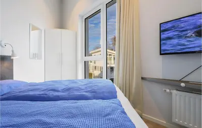 Ein Bett oder Betten in einem Zimmer der Unterkunft Dünenvilla 11, Whg 9