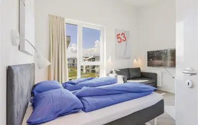 Ein Bett oder Betten in einem Zimmer der Unterkunft Dünenvilla 11, Whg 10