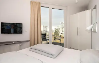 Ein Bett oder Betten in einem Zimmer der Unterkunft Dünenvilla 14, Whg 7