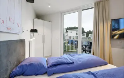 Ein Bett oder Betten in einem Zimmer der Unterkunft Dünenvilla 15, Whg 4