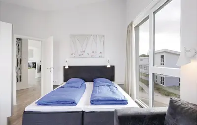 Ein Bett oder Betten in einem Zimmer der Unterkunft Dünenvilla 16, Whg 10