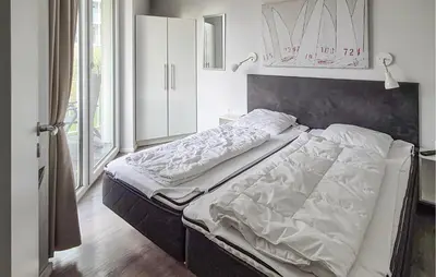 Ein Bett oder Betten in einem Zimmer der Unterkunft Dünenvilla 18, Whg 3