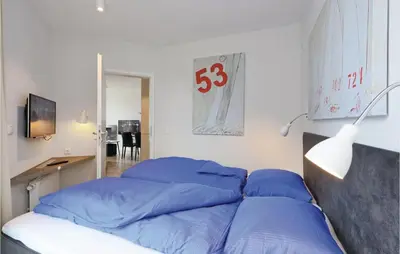 Ein Bett oder Betten in einem Zimmer der Unterkunft Dünenvilla 20, Whg 3
