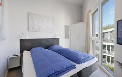 Ein Bett oder Betten in einem Zimmer der Unterkunft Dünenvilla 21, Whg 9