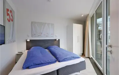 Ein Bett oder Betten in einem Zimmer der Unterkunft Dünenvilla 22, Whg 6