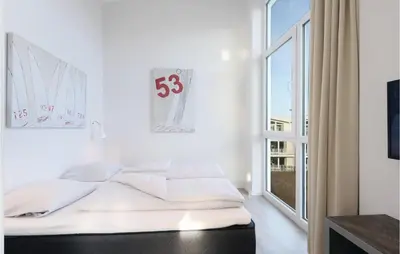 Ein Bett oder Betten in einem Zimmer der Unterkunft Dünenvilla 5, Whg 5
