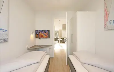 Ein Bett oder Betten in einem Zimmer der Unterkunft Dünenvilla 6, Whg 1