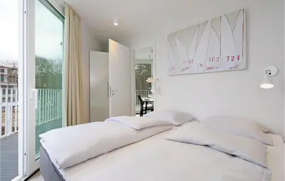 Ein Bett oder Betten in einem Zimmer der Unterkunft Dünenvilla 7, Whg 1
