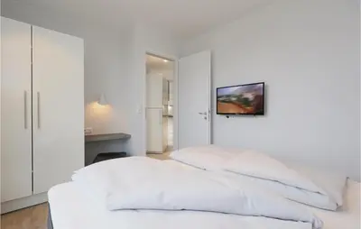 Ein Bett oder Betten in einem Zimmer der Unterkunft Dünenvilla 7, Whg 1