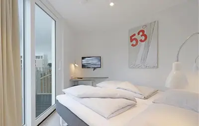 Ein Bett oder Betten in einem Zimmer der Unterkunft Dünenvilla 7, Whg 4