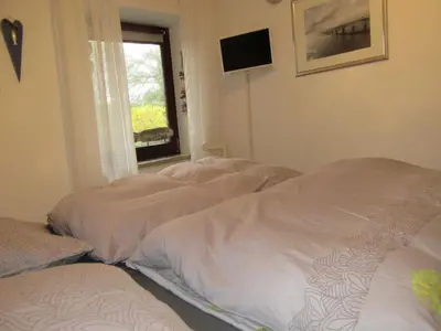 Ein Bett oder Betten in einem Zimmer der Unterkunft Lütt Hüs