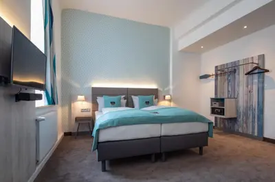 Ein Bett oder Betten in einem Zimmer der Unterkunft Holiday Inn - the niu, Rig Lübeck by IHG