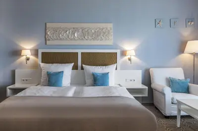 Ein Bett oder Betten in einem Zimmer der Unterkunft Mein Strandhaus - Hotel, Restaurant & Schwimmbad