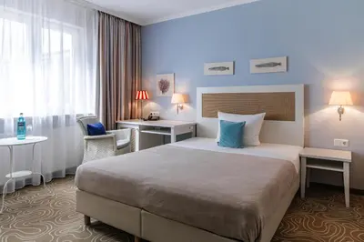 Ein Bett oder Betten in einem Zimmer der Unterkunft Mein Strandhaus - Hotel, Restaurant & Schwimmbad