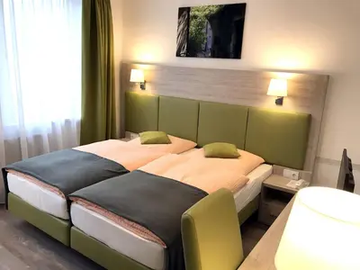 Ein Bett oder Betten in einem Zimmer der Unterkunft Hotel Hinz