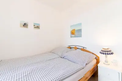 Ein Bett oder Betten in einem Zimmer der Unterkunft Ferienwohnung App. 9 Haus Duckdalben