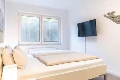 Ein Bett oder Betten in einem Zimmer der Unterkunft Ferienwohnung Strandhaus Möwenberg App.2
