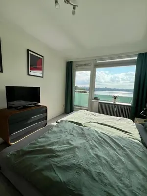 Ein Bett oder Betten in einem Zimmer der Unterkunft Panoramablick über den See