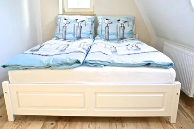 Ein Bett oder Betten in einem Zimmer der Unterkunft Gästhuus - Urlaub aan de Ostsee