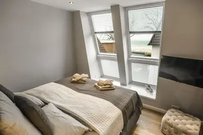 Ein Bett oder Betten in einem Zimmer der Unterkunft Beach House Penthousewohnung Düne