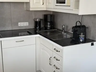 Küche/Küchenzeile in der Unterkunft Scharbeutz 2- Zimmer- Luxus Apartment mit eigener Sauna