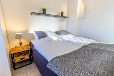 Ein Bett oder Betten in einem Zimmer der Unterkunft Scharbeutz 2- Zimmer- Luxus Apartment mit eigener Sauna