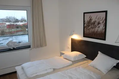 Ein Bett oder Betten in einem Zimmer der Unterkunft Dünenhaus Wohnung 7