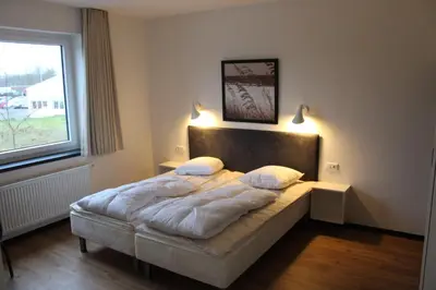Ein Bett oder Betten in einem Zimmer der Unterkunft Dünenhaus Wohnung 8