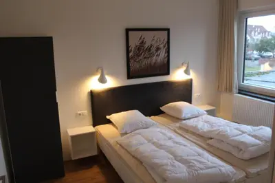 Ein Bett oder Betten in einem Zimmer der Unterkunft Dünenhaus Wohnung 8