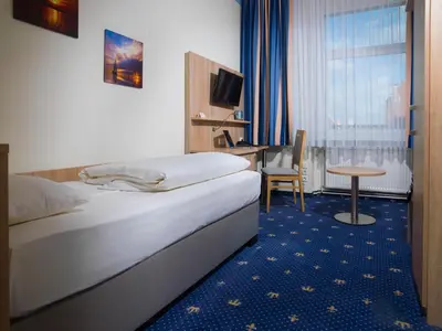 Ein Bett oder Betten in einem Zimmer der Unterkunft Hotel Deutscher Kaiser