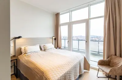 Ein Bett oder Betten in einem Zimmer der Unterkunft Dockside Travemünde