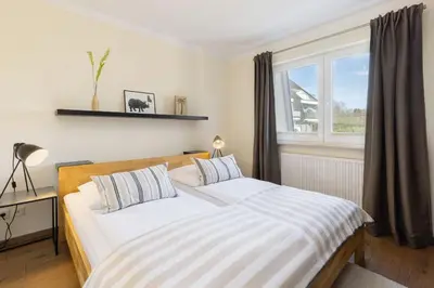 Ein Bett oder Betten in einem Zimmer der Unterkunft Baltic Sea Lodge Küstenglanz