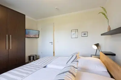 Ein Bett oder Betten in einem Zimmer der Unterkunft Baltic Sea Lodge Küstenglanz