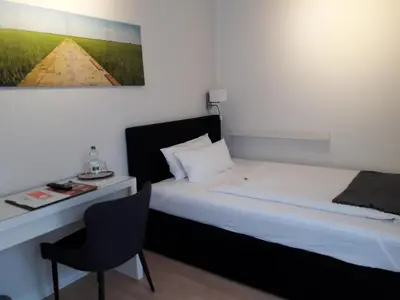 Ein Bett oder Betten in einem Zimmer der Unterkunft Hotel Herrenhof