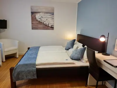 Ein Bett oder Betten in einem Zimmer der Unterkunft Hotel Herrenhof
