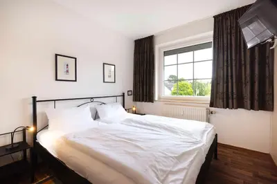 Ein Bett oder Betten in einem Zimmer der Unterkunft (DKK11B) Ferienwohnung Seegras